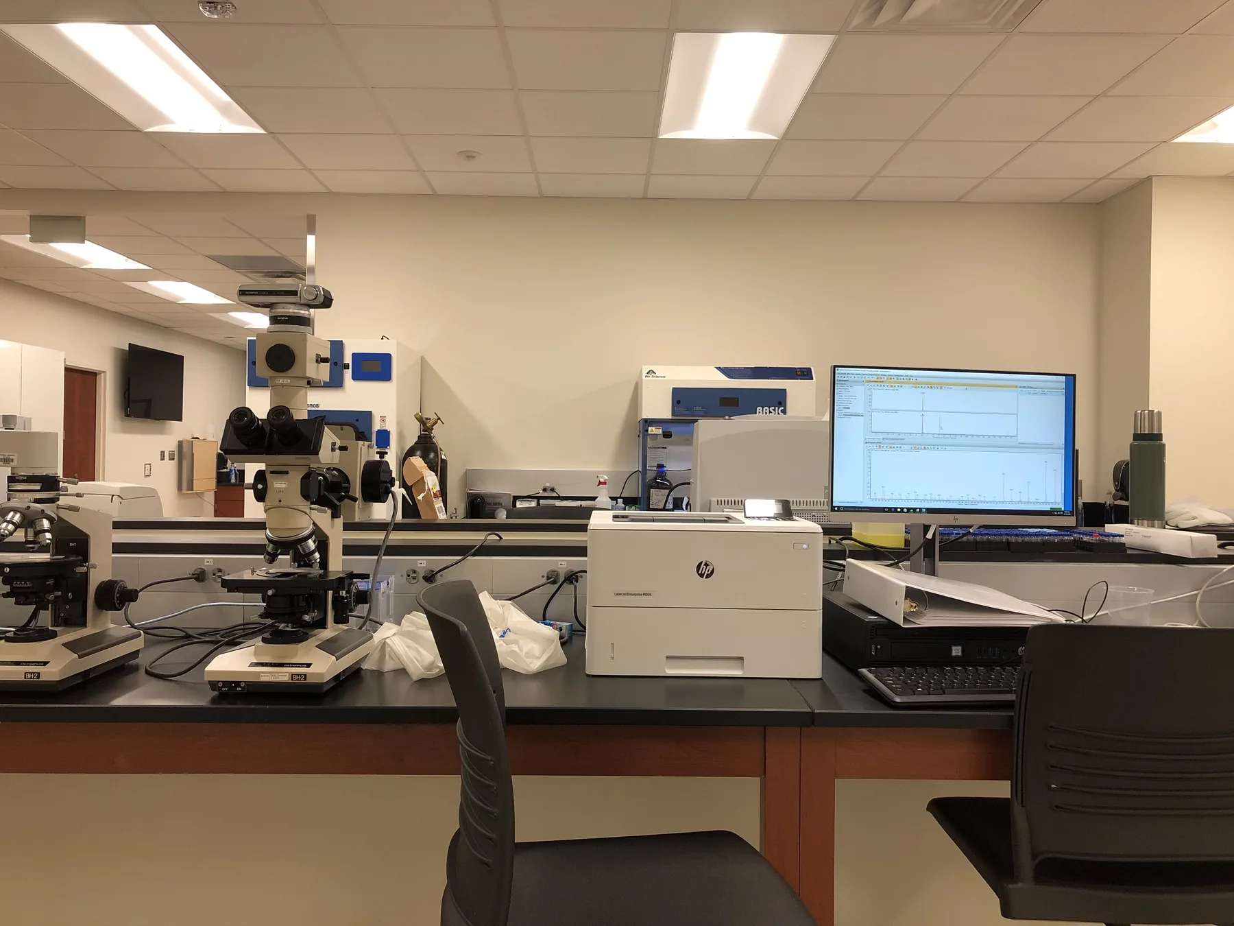 Microscopes, computers, analytical instruments, and workbenches fill a forensic science laboratory at Bowling Green State University.